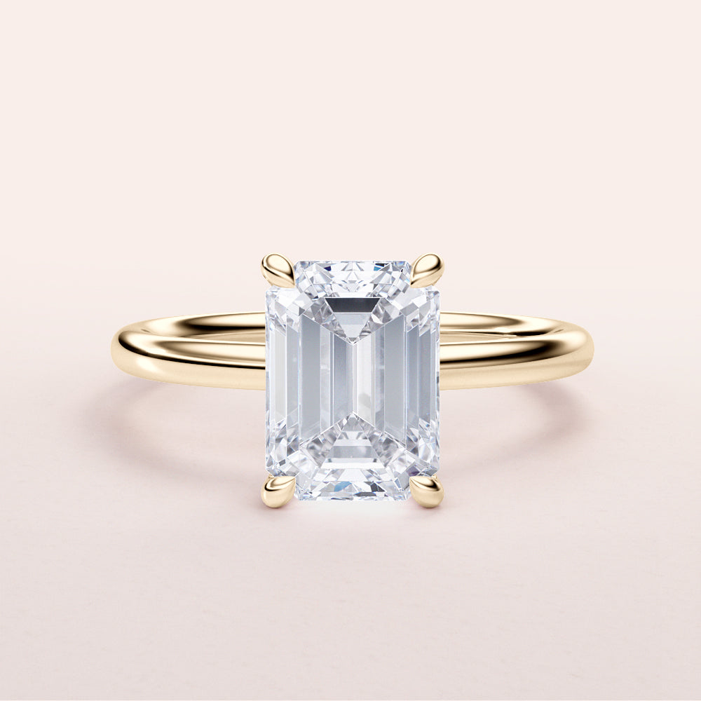 Elegant 14K yellow gold emerald-cut diamond engagement ring, perfect for timeless sophistication.|




#14KRecycledYellowGold
#18KRecycledYellowGold





