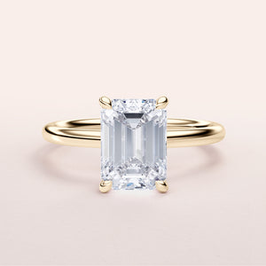 Elegant 14K yellow gold emerald-cut diamond engagement ring, perfect for timeless sophistication.