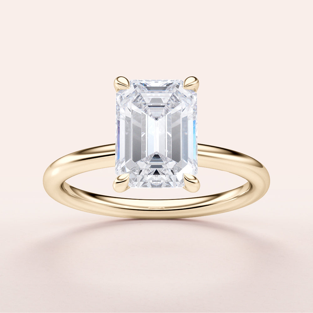 Elegant emerald cut diamond solitaire ring in a slim 14K or 18K gold band, showcasing timeless sophistication.|




#14KRecycledYellowGold
#18KRecycledYellowGold





