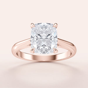 Elegant cushion-shaped diamond engagement ring in Rose Gold, available in 14K & 18K gold or platinum. Polished band design.