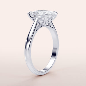 "White gold solitaire marquise diamond engagement ring in 14K, 18K, or platinum, featuring classic prong setting and timeless elegance."