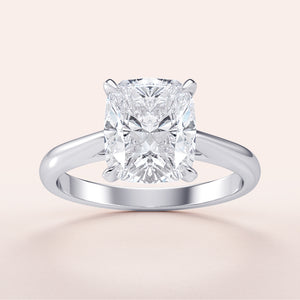 Cushion classic solitaire engagement ring in 14K or 18K white gold, featuring a radiant cut diamond for timeless elegance.