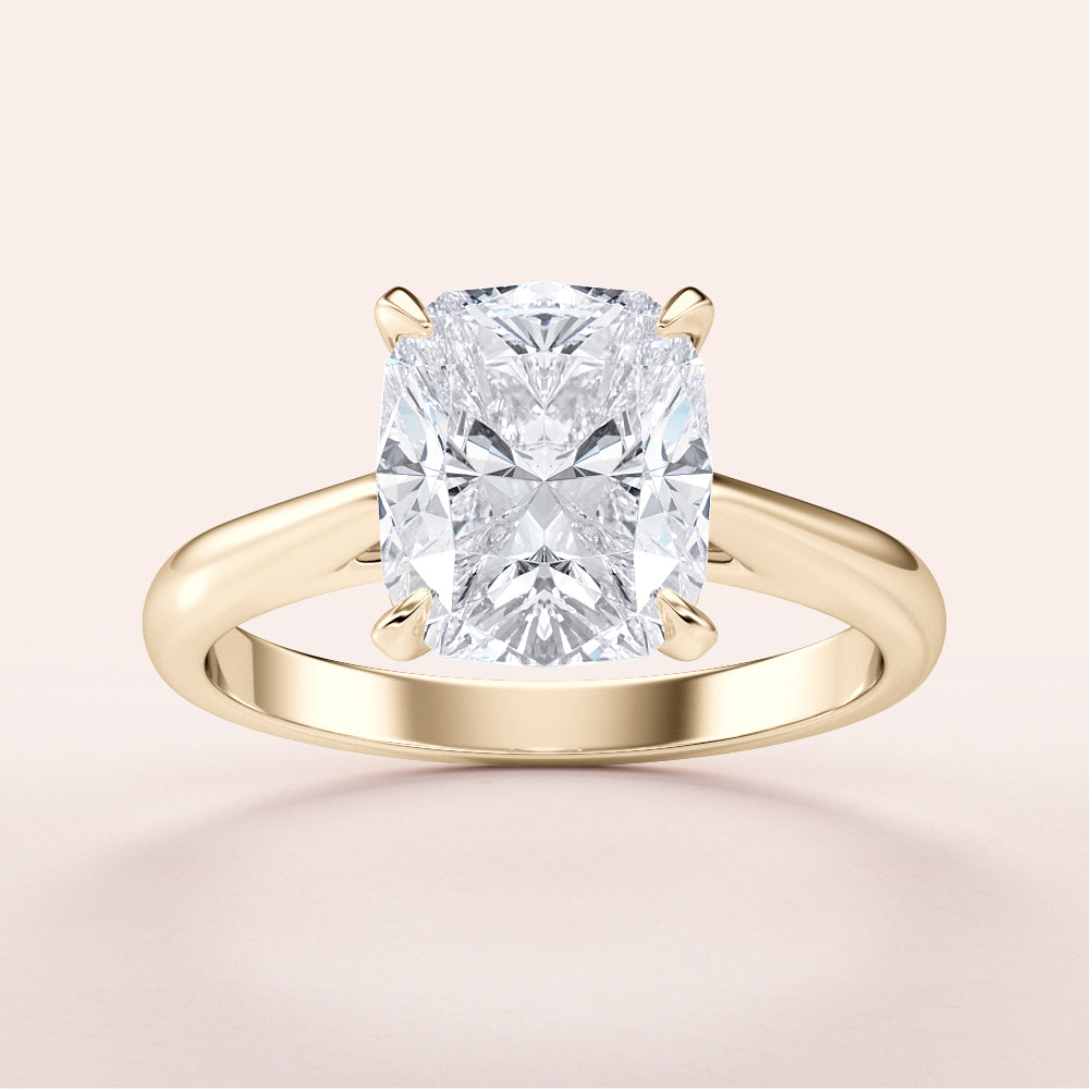 Close-up view of a stunning 14K or 18K yellow gold cushion cut diamond engagement ring, showcasing its classic cathedral setting.|




#14KRecycledYellowGold
#18KRecycledYellowGold





