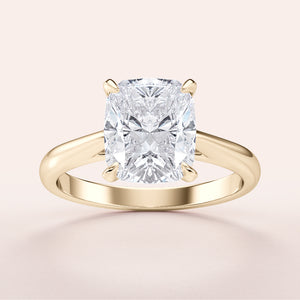 Close-up view of a stunning 14K or 18K yellow gold cushion cut diamond engagement ring, showcasing its classic cathedral setting.