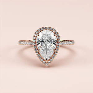 Elegant pear-shaped diamond ring with halo setting in 14K/18K rose gold, perfect for engagements and special occasions.