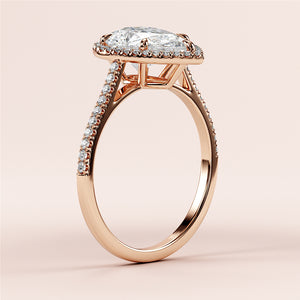 Elegant 14K rose gold engagement ring featuring a pear-shaped diamond with diamond-encrusted band, showcasing exquisite craftsmanship.