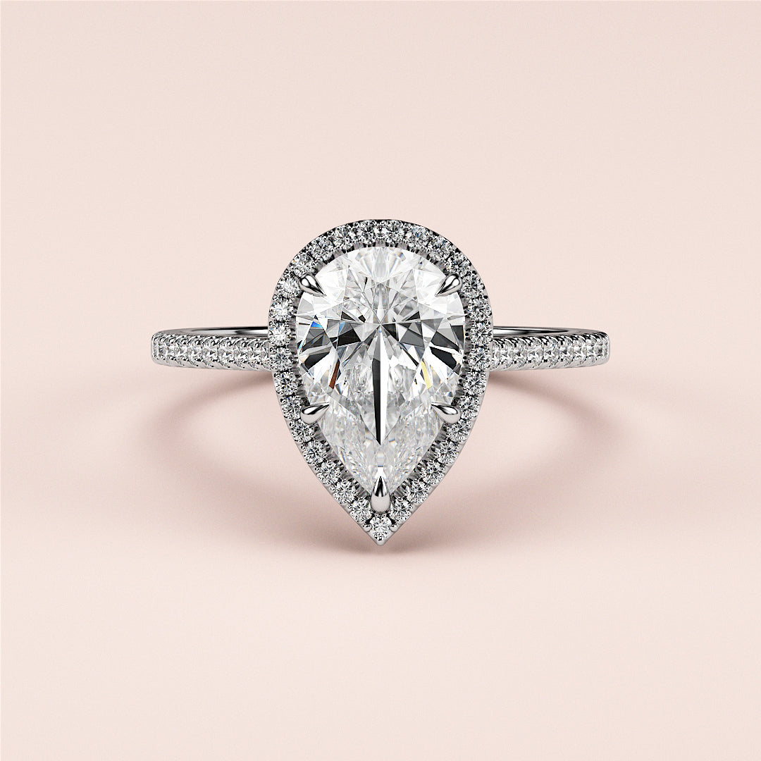 "Elegant pear-shaped halo engagement ring in 14K or 18K gold or platinum, featuring a stunning central diamond and pave accents."