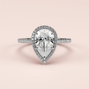 "Elegant pear-shaped halo engagement ring in 14K or 18K gold or platinum, featuring a stunning central diamond and pave accents."
