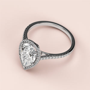 Elegant pear-shaped diamond engagement ring in 14K or 18K gold or platinum, adorned with delicate pave-set diamonds.
