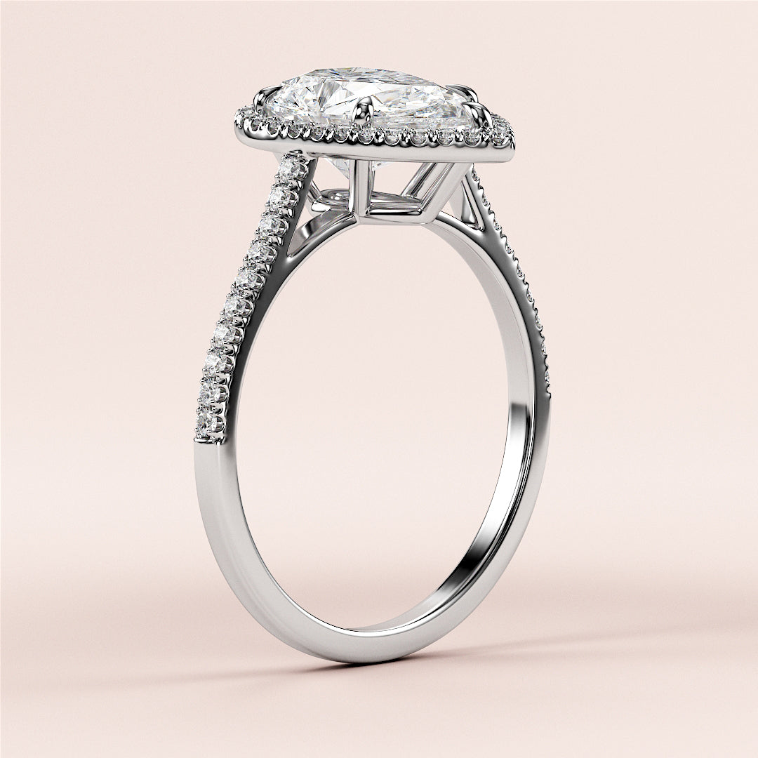 Elegant 14K white gold engagement ring featuring a pear-shaped diamond, accented withPave diamonds on the band.