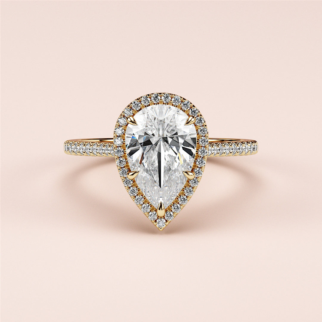 Elegant 14K and 18K gold pear-shaped diamond engagement ring with halo and pave band, perfect for your timeless romance.