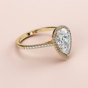 "Elegant pear-shaped diamond engagement ring in 14K gold with a pave diamond band, exuding timeless sophistication."