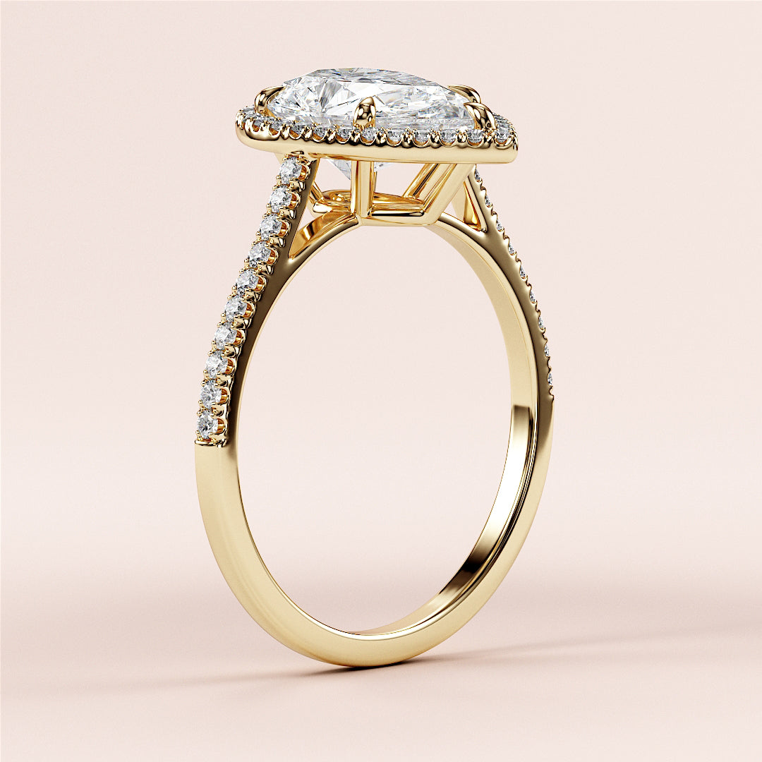 Elegant 14K/18K yellow gold engagement ring with pear-shaped halo, featuring a captivating diamond and intricate pave accents.