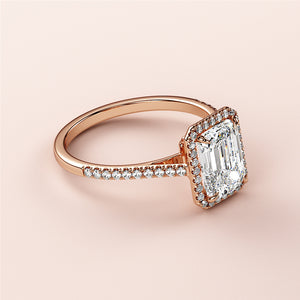 Elegant 14K rose gold emerald-cut diamond engagement ring with a dazzling halo, perfect for timeless sophistication.
