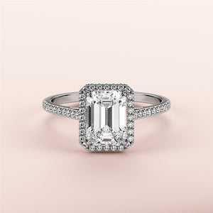 Elegant emerald-cut diamond engagement ring with halo, available in 14K, 18K, or platinum. A timeless symbol of love.