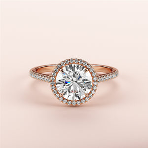 Elegant 14K or 18K rose gold engagement ring featuring a round-cut diamond, halo setting, and pave band. Perfect for your proposal.