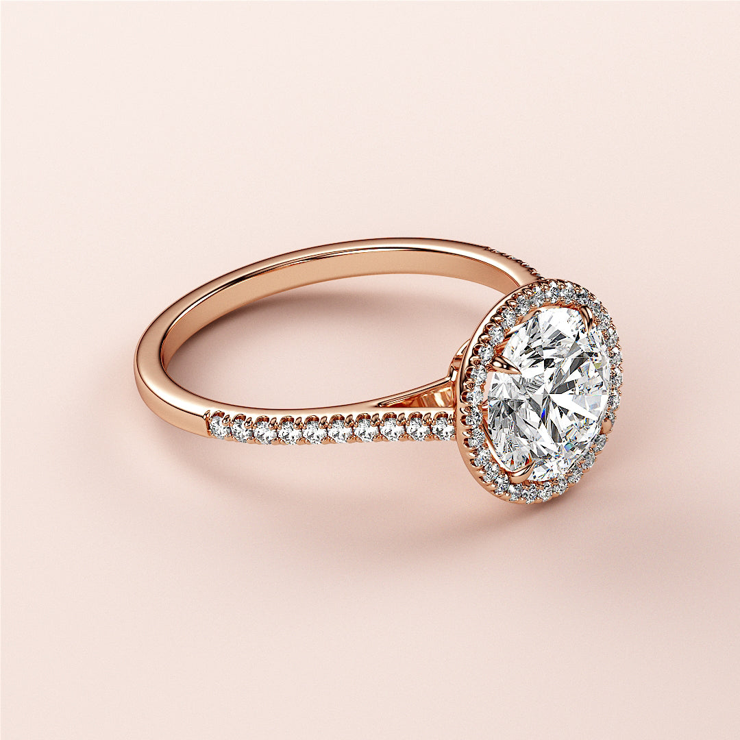 Stunning 14K rose gold engagement ring with a halo of diamonds andPave band, elegantly designed without a model.