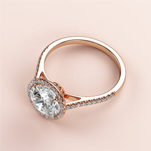 "14K rose gold engagement ring with oval diamond centerpiece and halo, elegantly displayed on a light pink background."