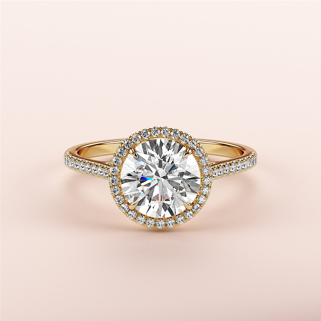 Elegant 14K/18K gold halo engagement ring with round brilliant diamond and sparkling pave band, showcasing timeless beauty.