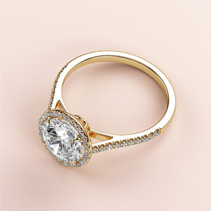 Elegant yellow gold 14K/18K engagement ring featuring an oval cut diamond with pave halo and band, set on a white background.