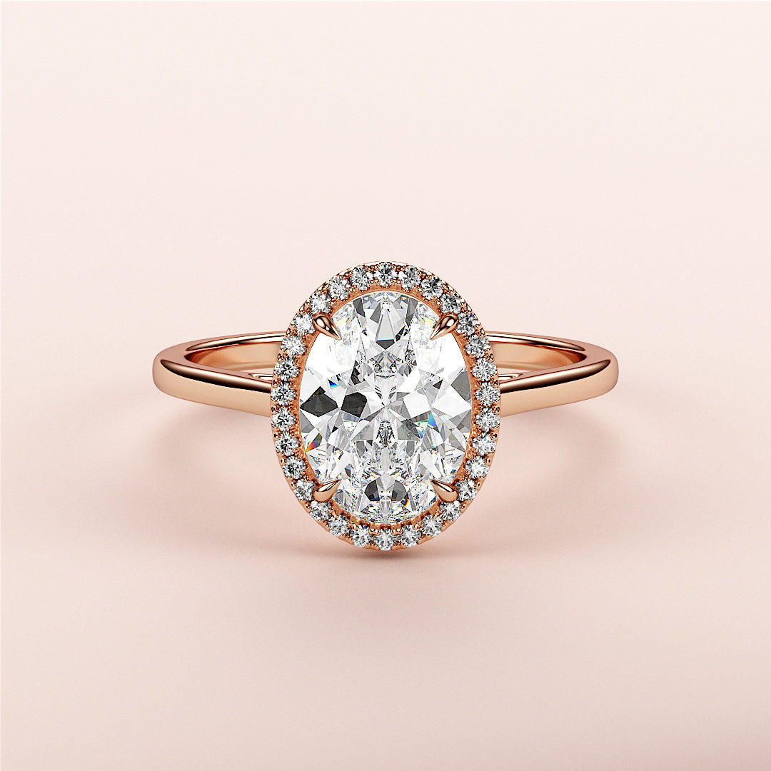 Exquisite 14K rose gold engagement ring showcasing an oval diamond centerpiece with a halo of smaller diamonds.