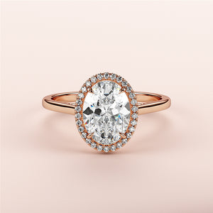 Exquisite 14K rose gold engagement ring showcasing an oval diamond centerpiece with a halo of smaller diamonds.