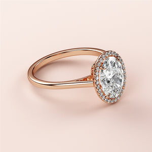 Elegant rose gold engagement ring with an oval diamond and halo, available in 14K, 18K, or platinum. Perfect for your special day.
