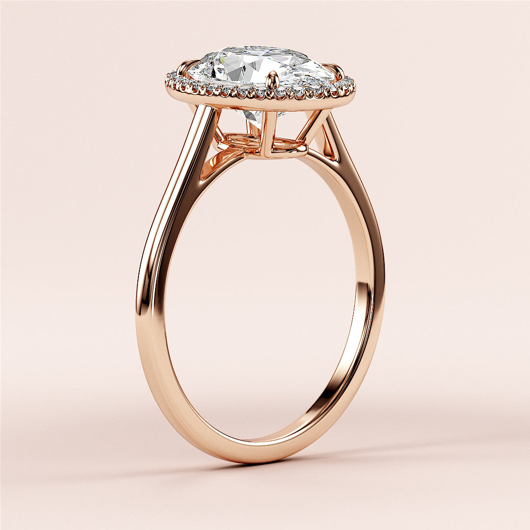 Elegant rose gold engagement ring with halo setting, featuring pear-shaped diamond, available in 14K, 18K, or platinum.|







#14KRecycledRoseGold
#18KRecycledRoseGold


