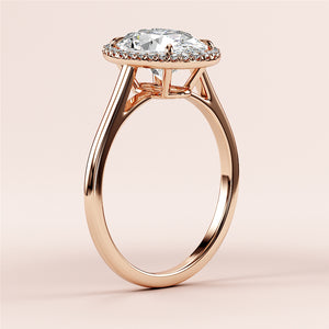 Elegant rose gold engagement ring with halo setting, featuring pear-shaped diamond, available in 14K, 18K, or platinum.