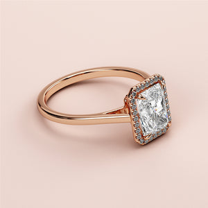 Elegant 14K or 18K rose gold engagement ring with radiant halo and rectangular-cut diamond, featuring a sparkling diamond band.