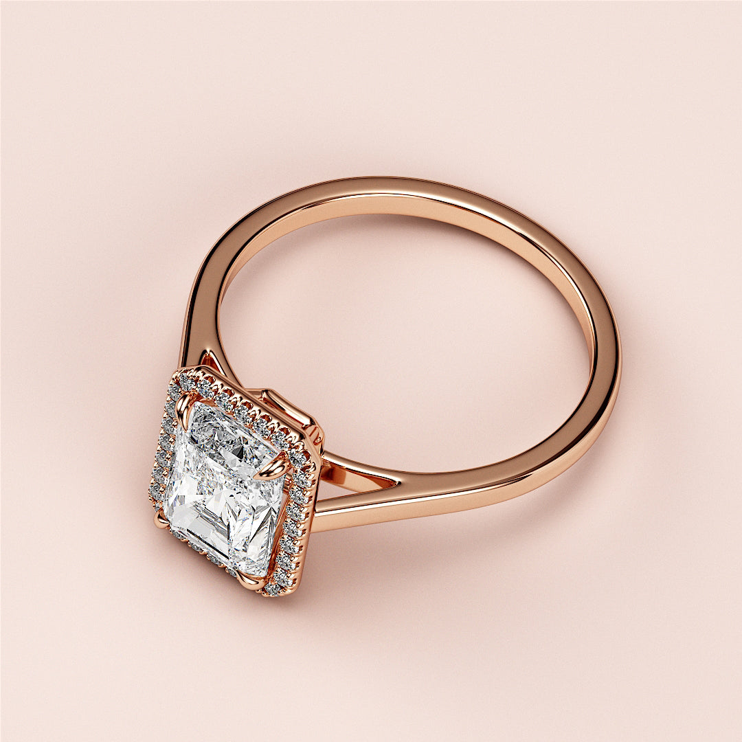 Radiant cut diamond engagement ring with halo setting in 14K/18K rose gold, displayed on a soft background.|







#14KRecycledRoseGold
#18KRecycledRoseGold


