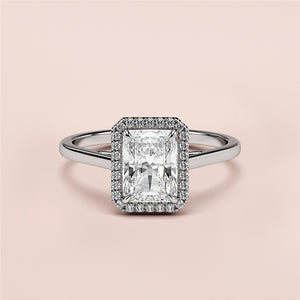 14K white gold radiant cut diamond halo engagement ring with pave setting, displayed on a neutral background.