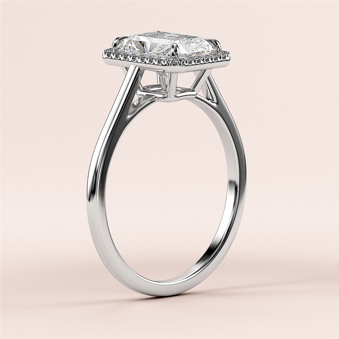 Elegant 14K or 18K white gold engagement ring featuring a radiant-cut diamond on a sleek band, set against a soft beige background.|

#14KRecycledWhiteGold
#18KRecycledWhiteGold








#Platinum