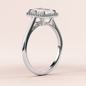 Elegant 14K or 18K white gold engagement ring featuring a radiant-cut diamond on a sleek band, set against a soft beige background.