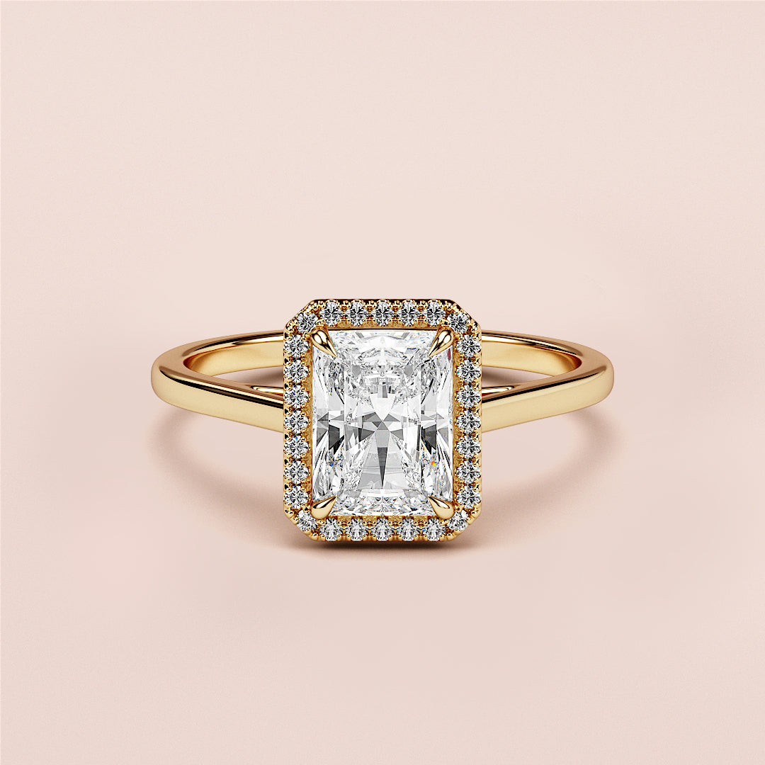 Radiant cut diamond halo engagement ring in 14K gold, featuring rectangular diamond center stone and polished band.|




#14KRecycledYellowGold
#18KRecycledYellowGold





