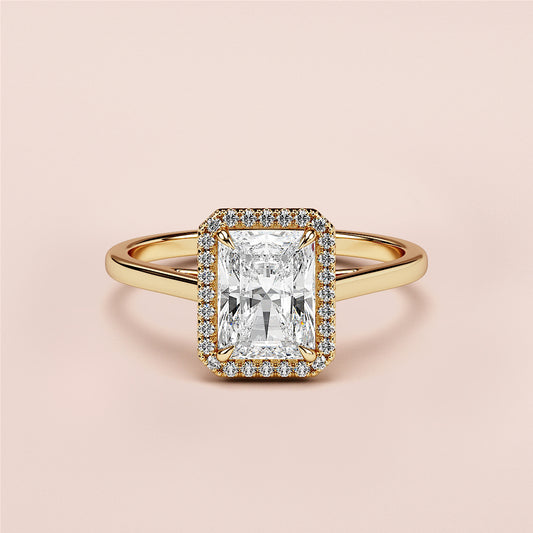 Radiant cut diamond halo engagement ring in 14K gold, featuring rectangular diamond center stone and polished band.