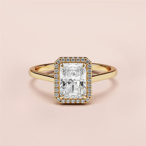 Radiant cut diamond halo engagement ring in 14K gold, featuring rectangular diamond center stone and polished band.