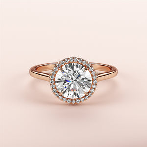 Elegant round halo diamond engagement ring in 14K or 18K rose gold, featuring a stunning halo of smaller diamonds.