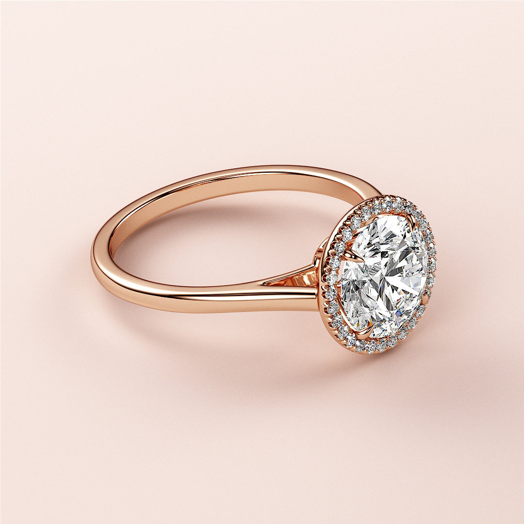 Elegant oval-shaped diamond halo ring in 14K rose gold, featuring a sparkling diamond centerpiece and a halo of smaller diamonds.|







#14KRecycledRoseGold
#18KRecycledRoseGold



