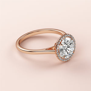 Elegant oval-shaped diamond halo ring in 14K rose gold, featuring a sparkling diamond centerpiece and a halo of smaller diamonds.
