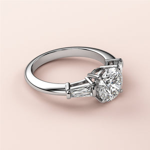Elegant round diamond engagement ring with baguette side stones in lustrous 14K or 18K gold or platinum. Not worn on model.
