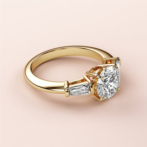 "Elegant round-cut diamond engagement ring in 14K or 18K yellow gold or platinum, featuring tapered baguette side diamonds."