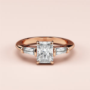 Radiant-cut diamond engagement ring with baguette side stones in a rose gold band, available in 14K, 18K, or platinum.