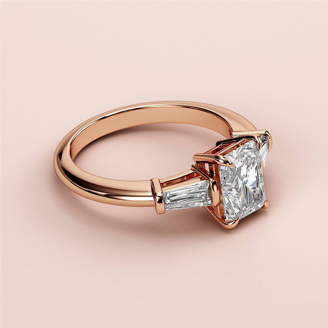 Rose gold engagement ring with princess-cut diamond and tapered baguettes, available in 14K, 18K, and platinum.