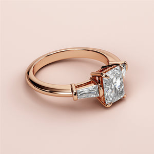 Rose gold engagement ring with princess-cut diamond and tapered baguettes, available in 14K, 18K, and platinum.