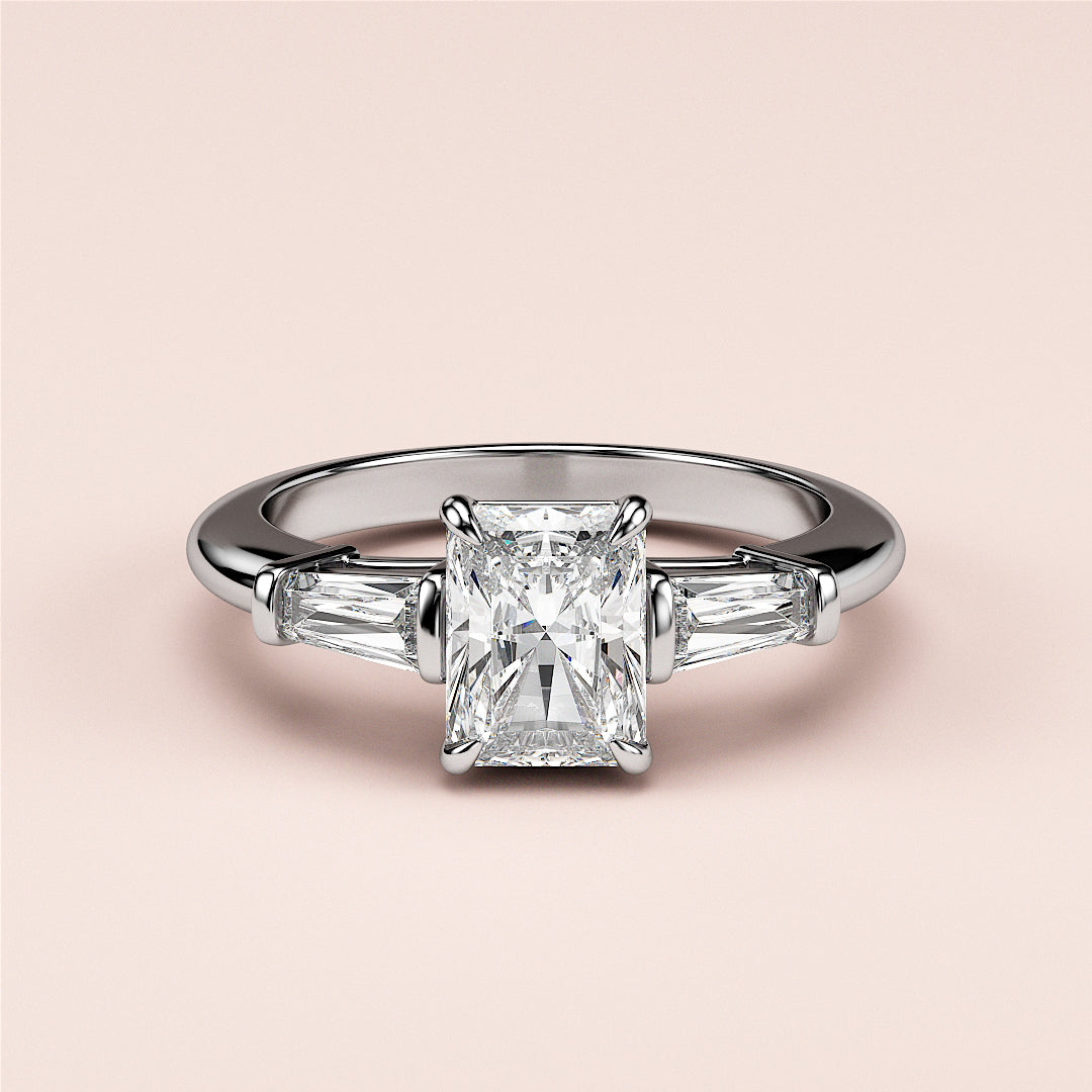 Elegant 14K or 18K white gold or platinum engagement ring with a radiant-cut diamond and tapered baguette diamonds.