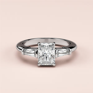 Elegant 14K or 18K white gold or platinum engagement ring with a radiant-cut diamond and tapered baguette diamonds.