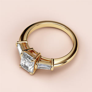 "14K or 18K yellow gold engagement ring featuring a radiant-cut diamond center stone and tapered baguette side stones."