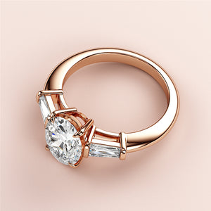 Stunning 14K or 18K rose gold engagement ring with oval three-stone design and tapered baguette diamonds, perfect for proposals.