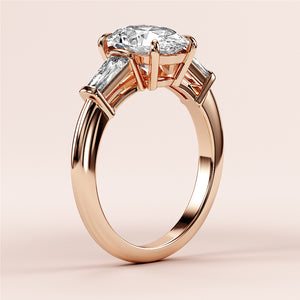 Elegant rose gold engagement ring with marquise-cut diamond and tapered baguette accents, available in 14K and 18K gold or platinum.